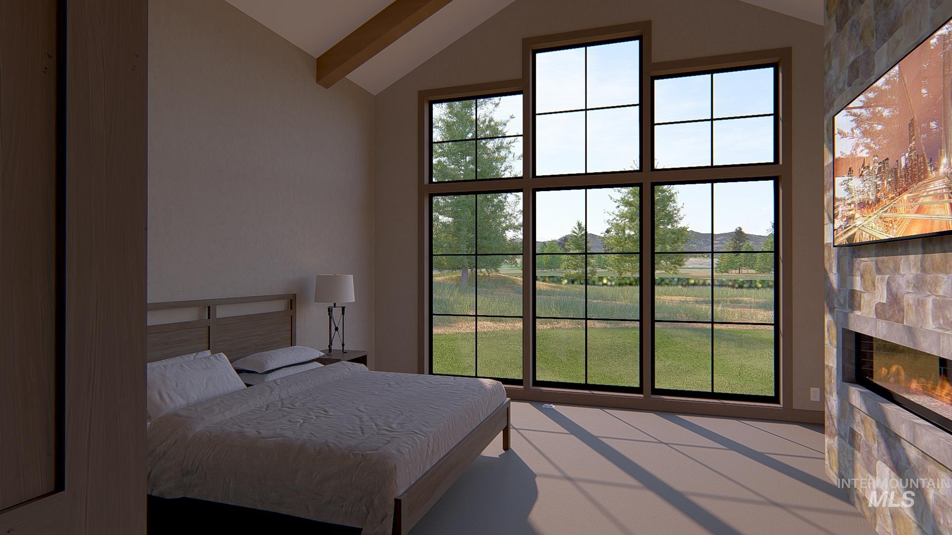 212 Rawhide Loop McCall, ID 83638 - Photo 18 of 28 Bedroom with vaulted ceiling, a tile fireplace, and multiple windows