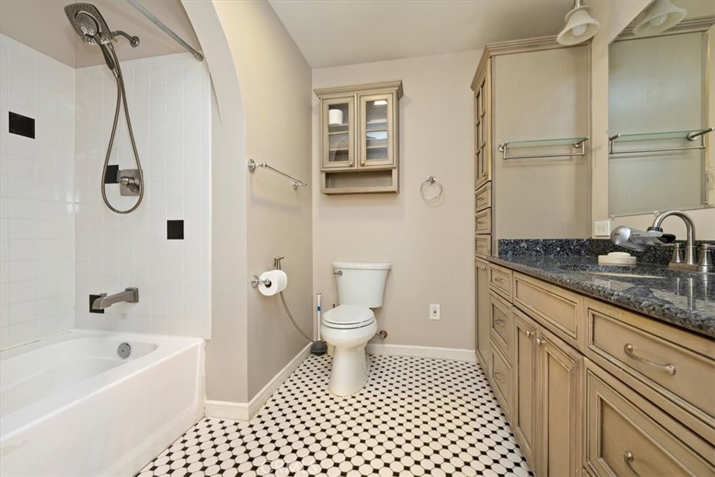 4336 6th Street Riverside, CA 92501 - Photo 12 of 19 a bathroom with a granite countertop sink a toilet and a bathtub