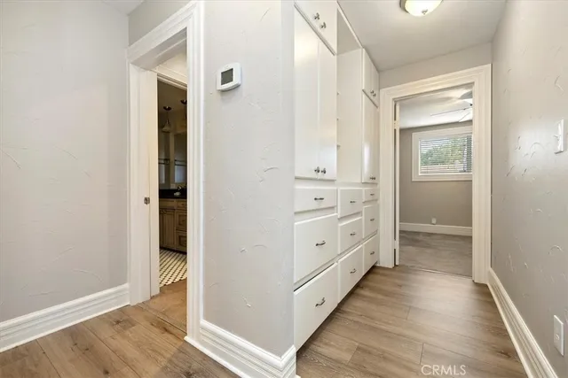 a view of a hallway with closet and wooden floor