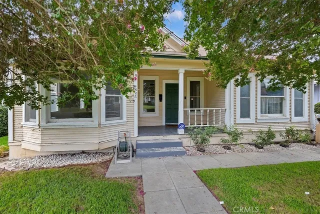 a front view of a house with garden