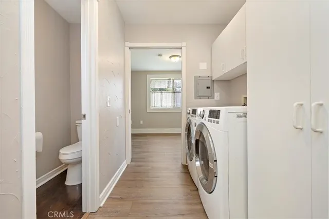 a view of a bathroom with washing machine and a washing machine