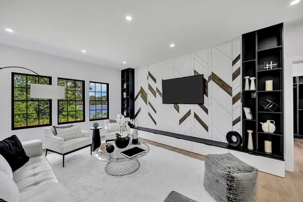 a living room with furniture and a floor to ceiling window