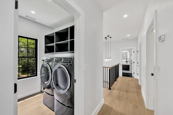 a view of a hallway with washer and dryer