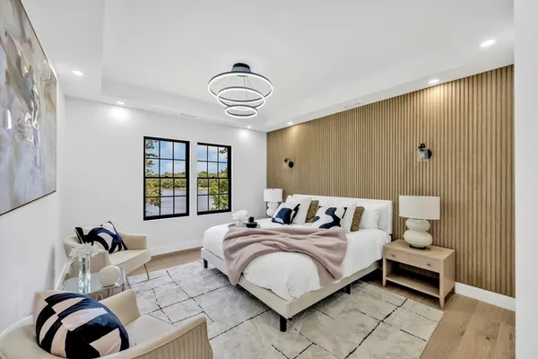 a bedroom with a bed and a chandelier