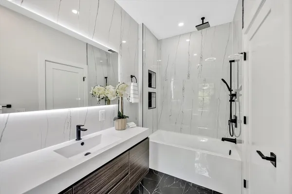 a bathroom with a bathtub and a shower
