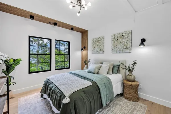 a bedroom with a bed and a window