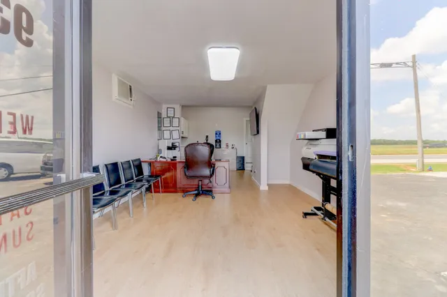 a bathroom with a sink and mirror with toilet