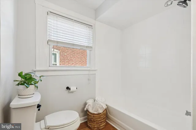 a bathroom with a toilet a sink and a window