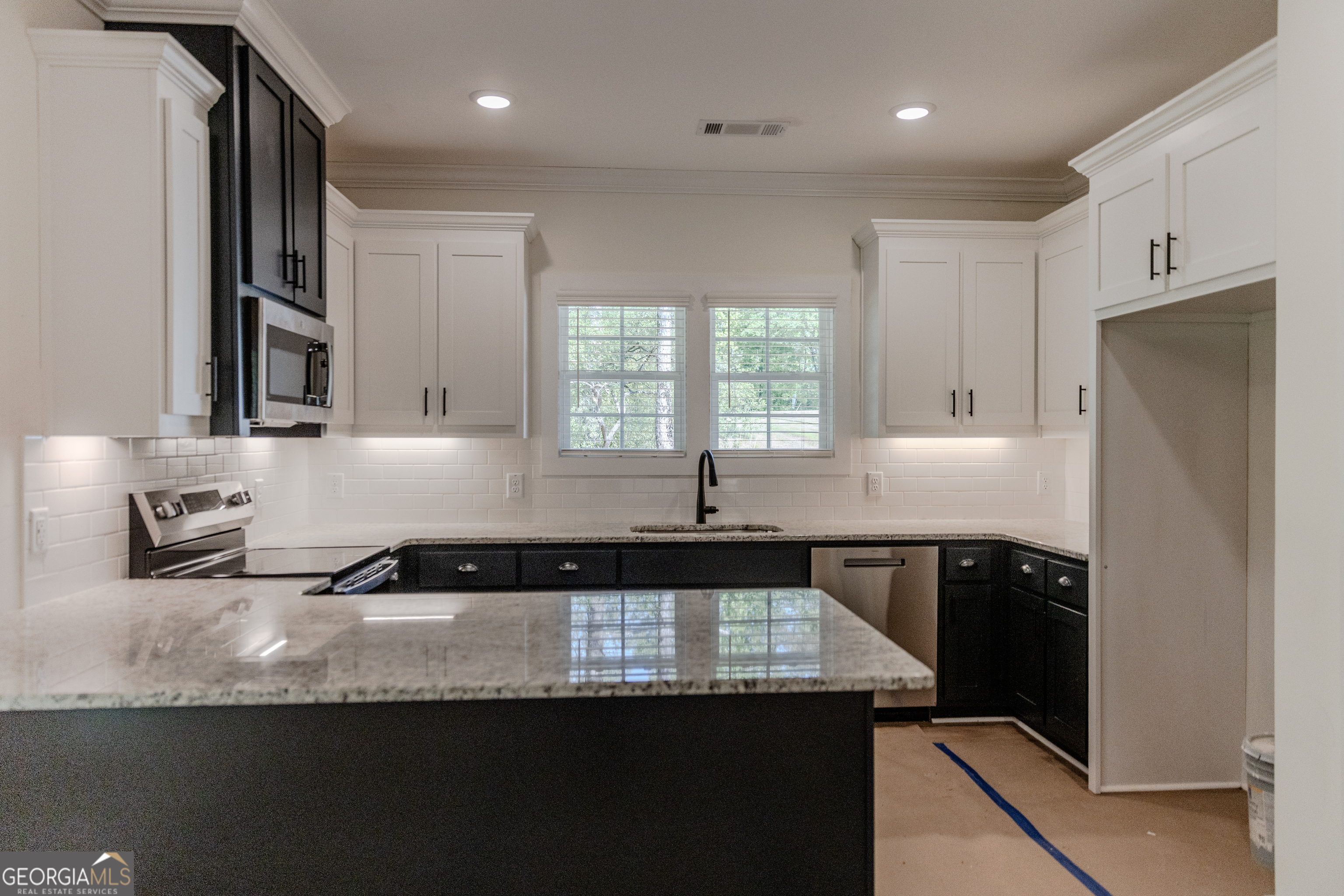 632 Campbell Road Covington, GA 30014 - Photo 8 of 60 a kitchen with granite countertop a sink a stove and refrigerator