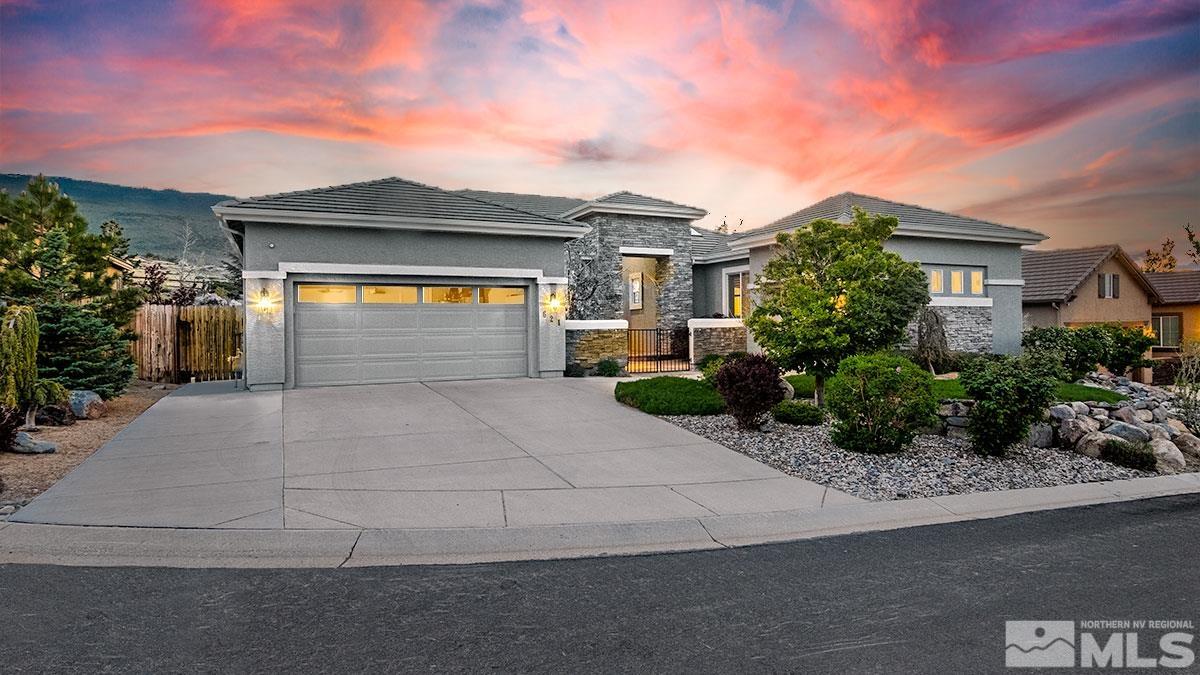 621 Rabbit Ridge Court Reno, NV 89511 - Photo 1 of 26 a front view of a house with a yard and garage