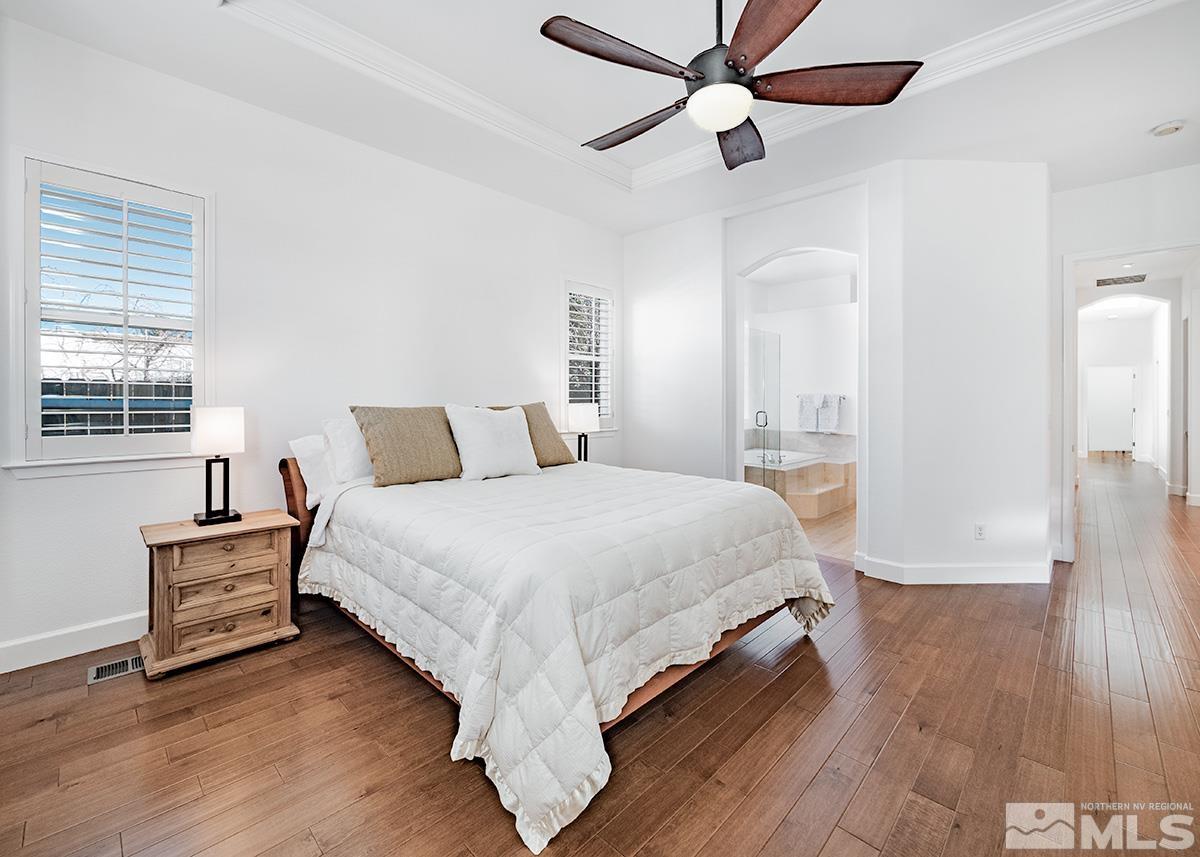 621 Rabbit Ridge Court Reno, NV 89511 - Photo 13 of 26 a bedroom with a bed and wooden floor