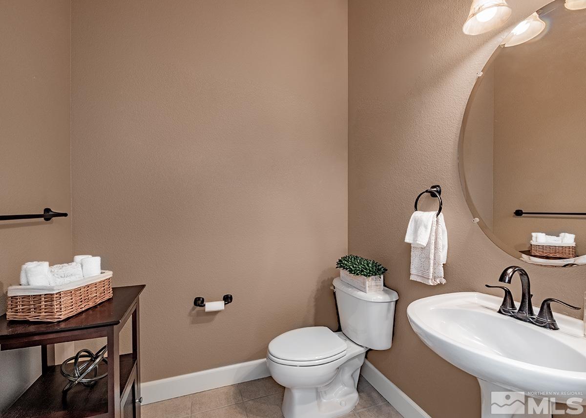 621 Rabbit Ridge Court Reno, NV 89511 - Photo 17 of 26 a bathroom with a toilet a sink and mirror