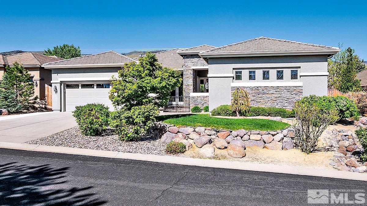 621 Rabbit Ridge Court Reno, NV 89511 - Photo 2 of 26 a front view of a house with a yard