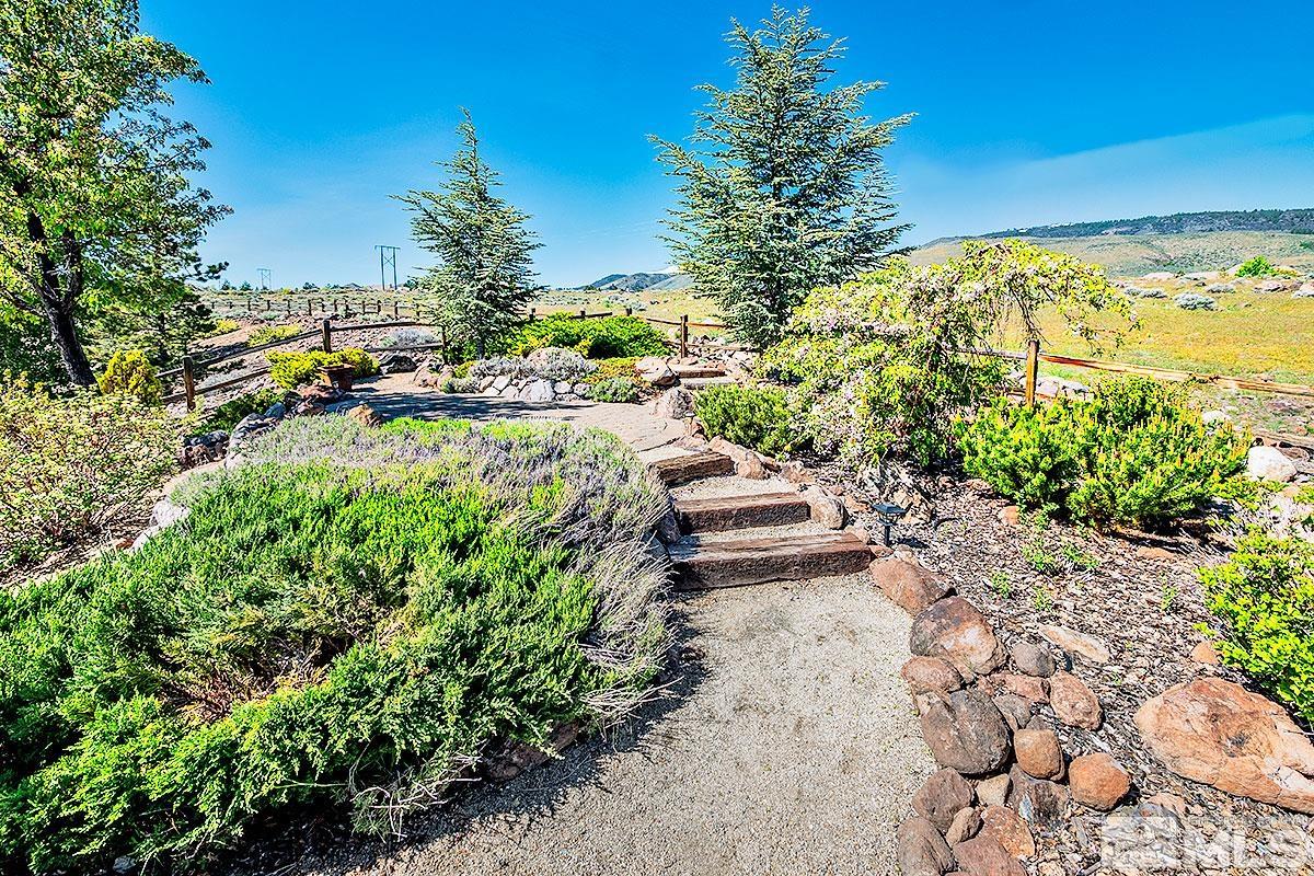 621 Rabbit Ridge Court Reno, NV 89511 - Photo 21 of 26 a view of a yard with plants and large trees
