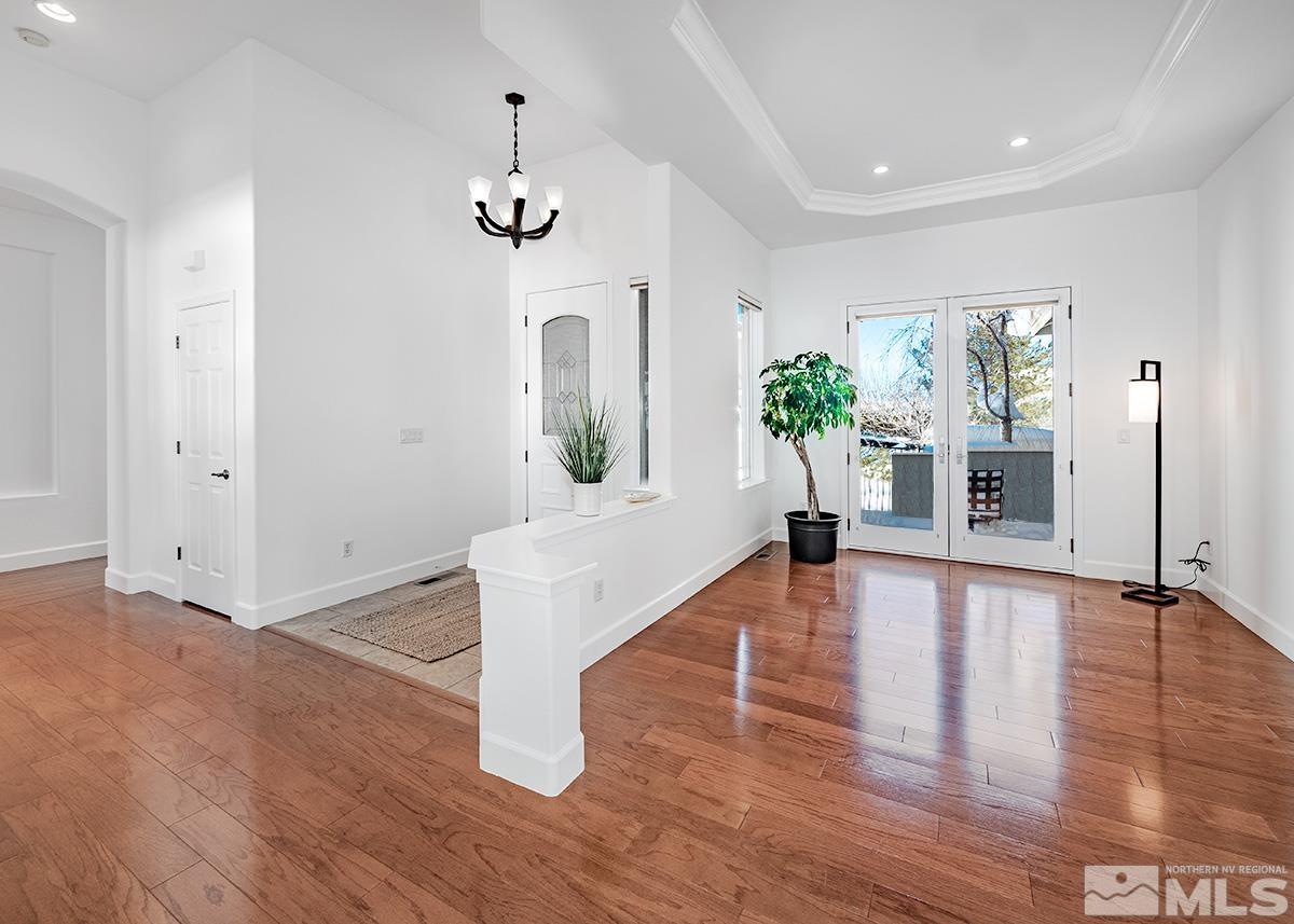 621 Rabbit Ridge Court Reno, NV 89511 - Photo 9 of 26 a living room with furniture and a chandelier