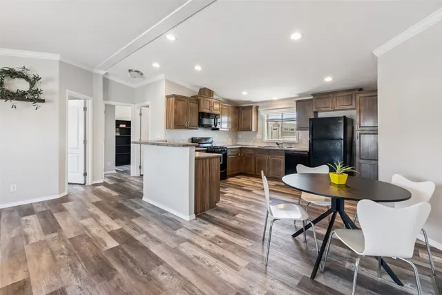 a kitchen with stainless steel appliances granite countertop a stove microwave and sink