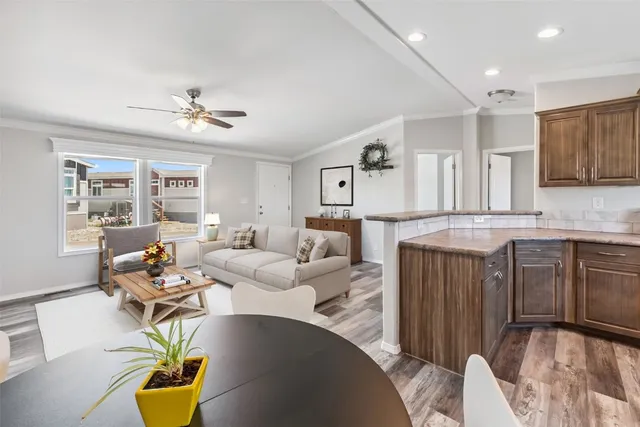 a living room with kitchen island furniture and a chandelier