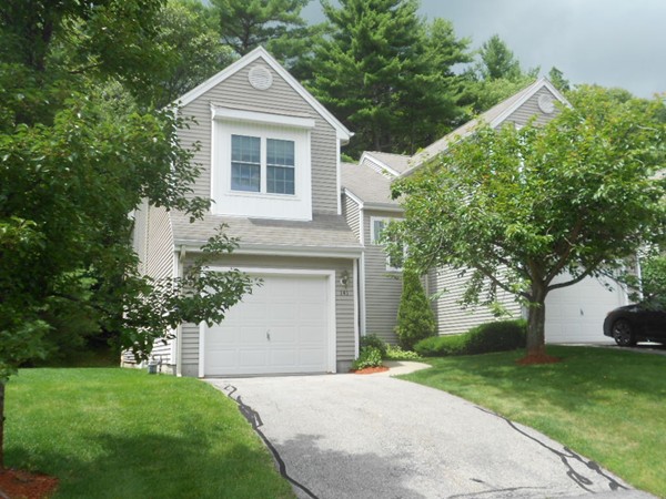 141 Lordvale Boulevard, Unit 141 Grafton, MA 01536 - Photo 1 of 23 a front view of a house with a yard and garage