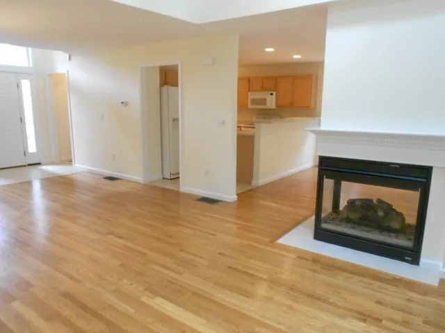 a view of an empty room and wooden floor