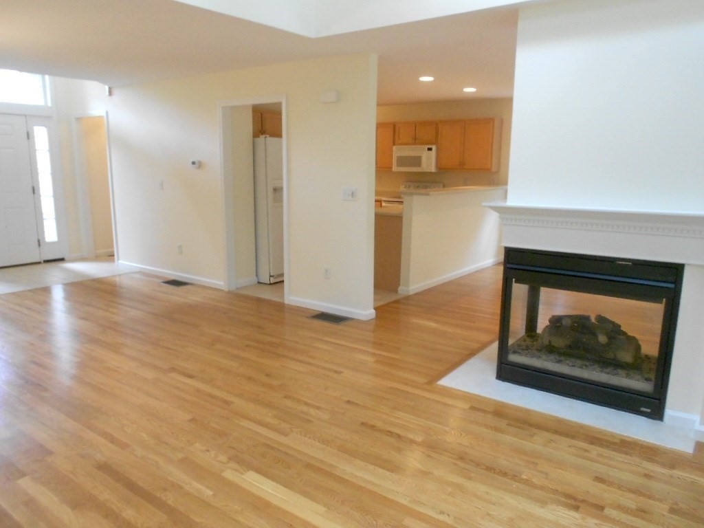 141 Lordvale Boulevard, Unit 141 Grafton, MA 01536 - Photo 11 of 23 a view of an empty room and wooden floor