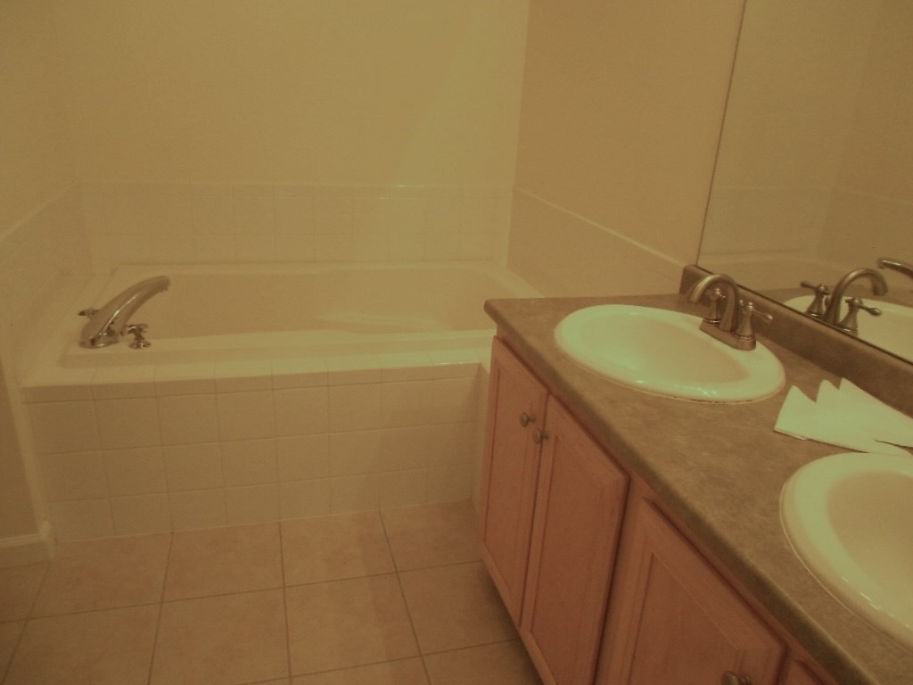 141 Lordvale Boulevard, Unit 141 Grafton, MA 01536 - Photo 19 of 23 a bathroom with a granite countertop sink and a mirror