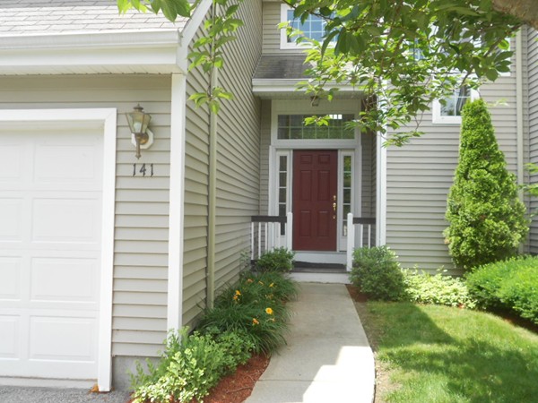 141 Lordvale Boulevard, Unit 141 Grafton, MA 01536 - Photo 2 of 23 a front view of a house with a garden
