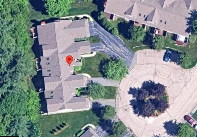 an aerial view of house with yard and swimming pool