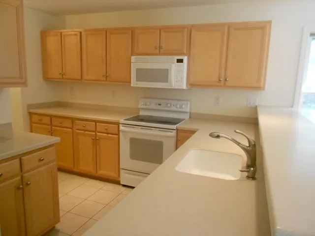a utility room with a sink washer and dryer