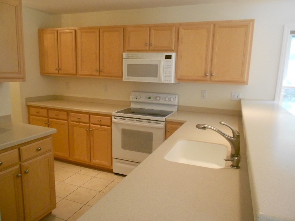141 Lordvale Boulevard, Unit 141 Grafton, MA 01536 - Photo 6 of 23 a utility room with a sink washer and dryer