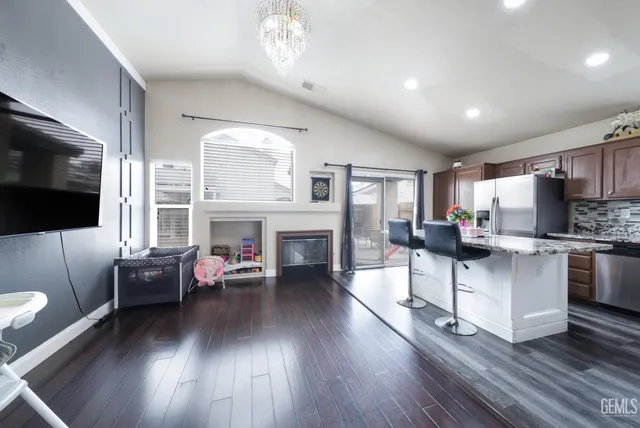 a kitchen with a refrigerator and a stove