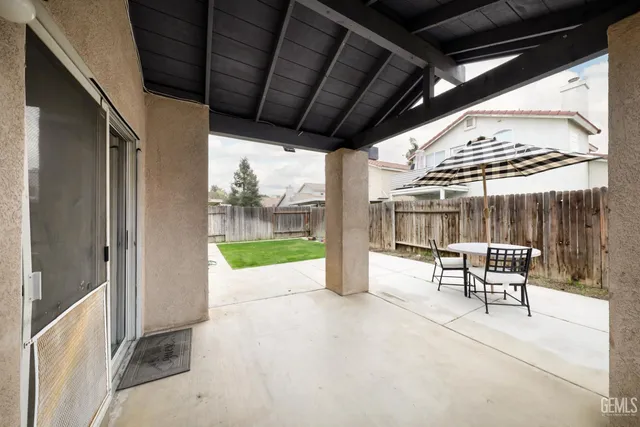 a patio with a table and chairs