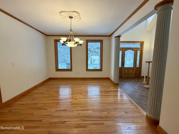a view of staircase with wooden floor and a chandelier