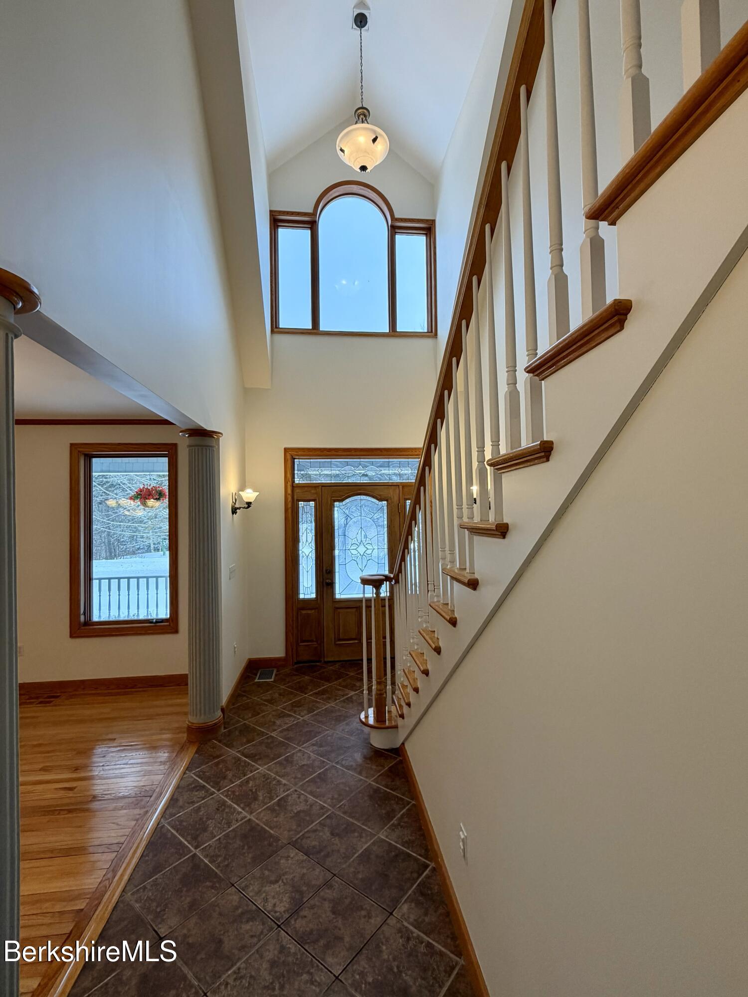 7 Poirot Road Florida, MA 01247 - Photo 20 of 57 a view of staircase with wooden floor and a chandelier