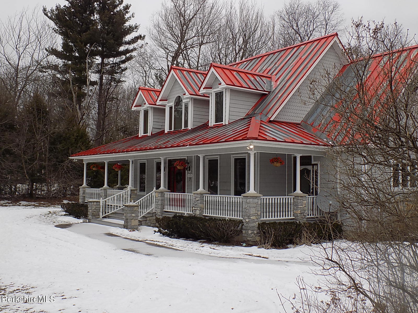 7 Poirot Road Florida, MA 01247 - Photo 2 of 57 a front view of a house with a yard covered in snow