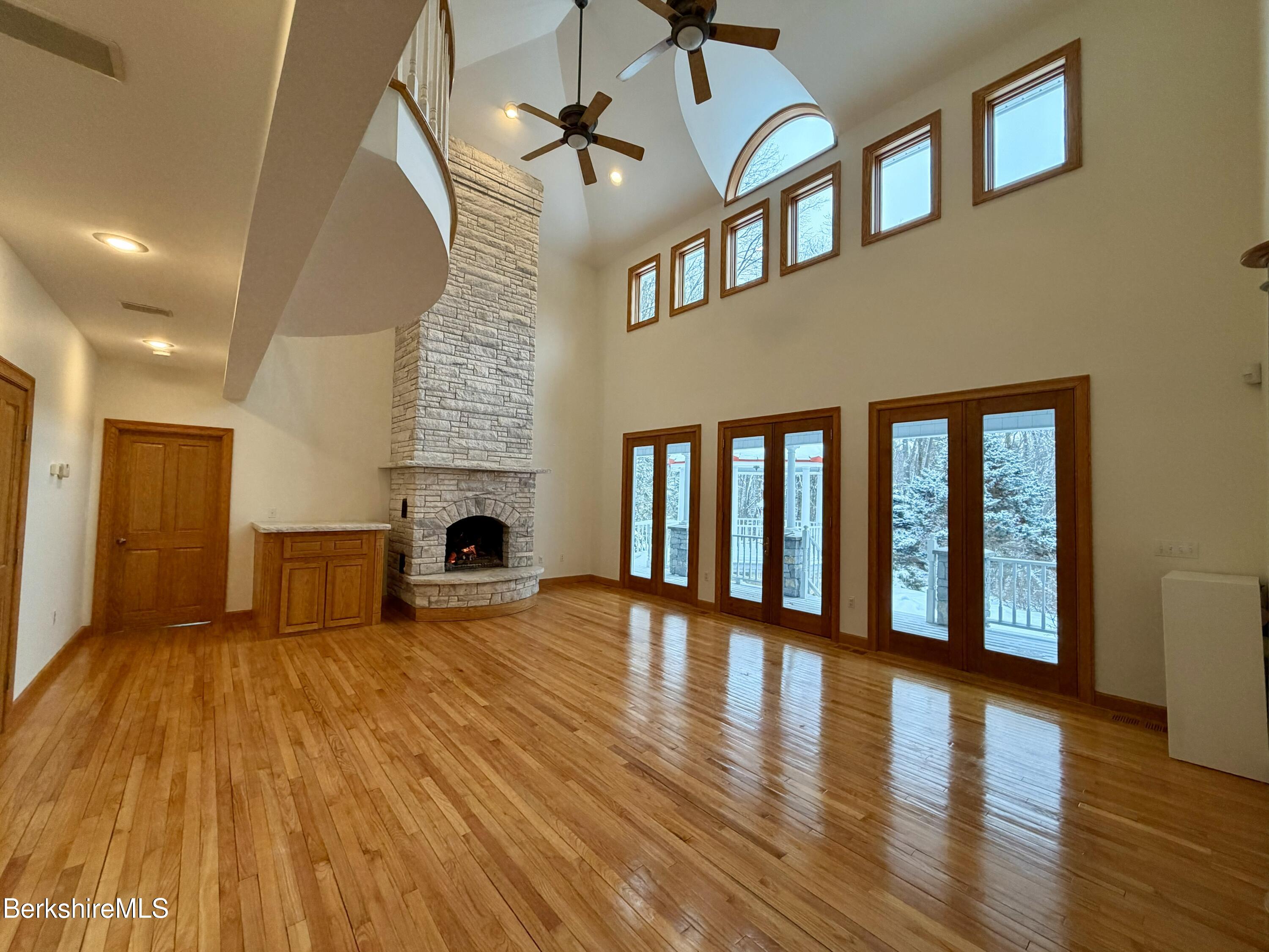 7 Poirot Road Florida, MA 01247 - Photo 24 of 57 a view of an empty room with wooden floor and a fireplace
