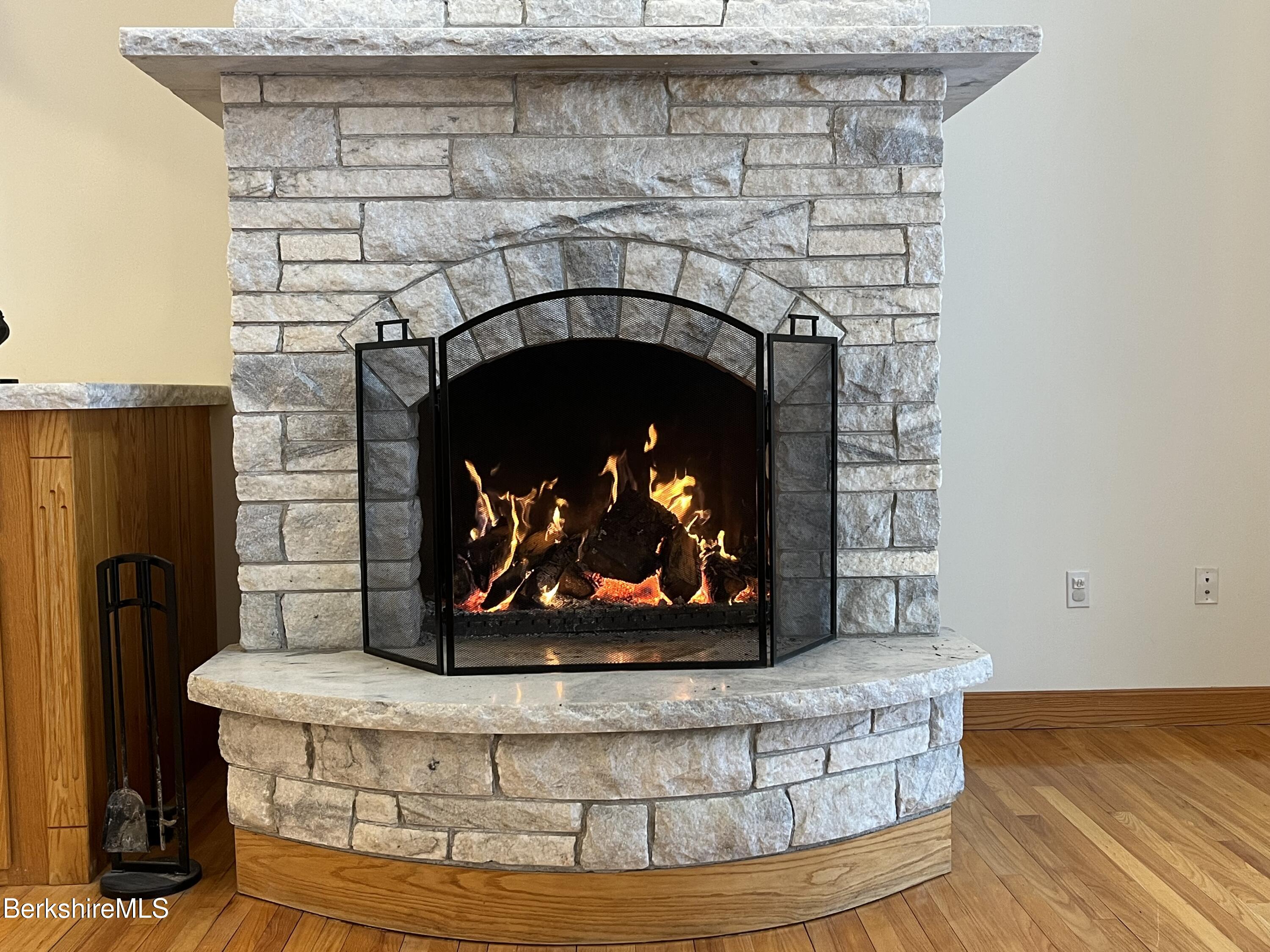 7 Poirot Road Florida, MA 01247 - Photo 26 of 57 a close view of a fireplace with wooden floor