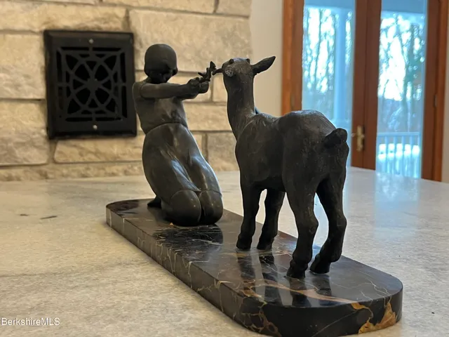 a spacious bedroom with a bed and a dresser next to a window