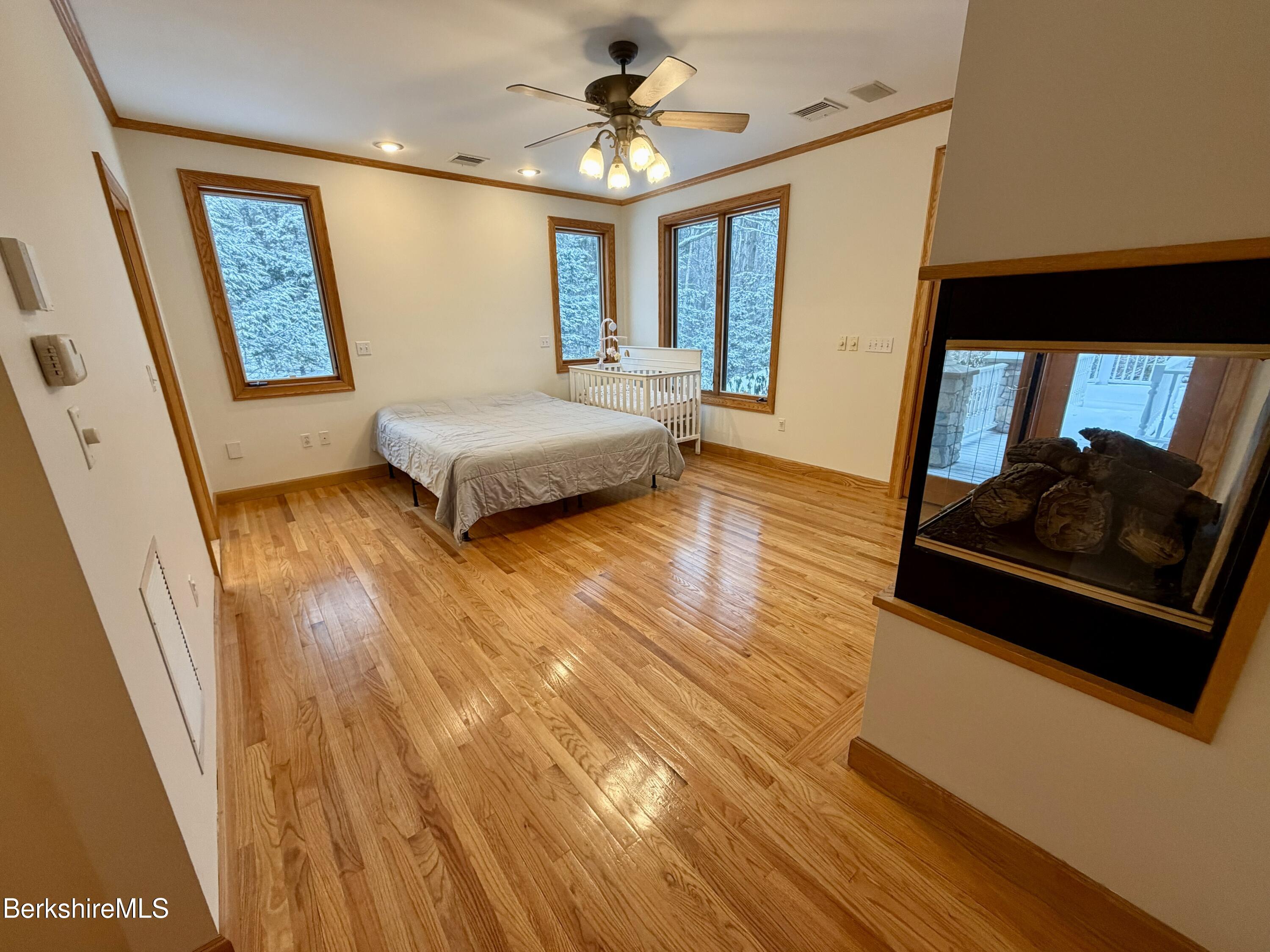 7 Poirot Road Florida, MA 01247 - Photo 32 of 57 a spacious bedroom with a bed and a dresser next to a window