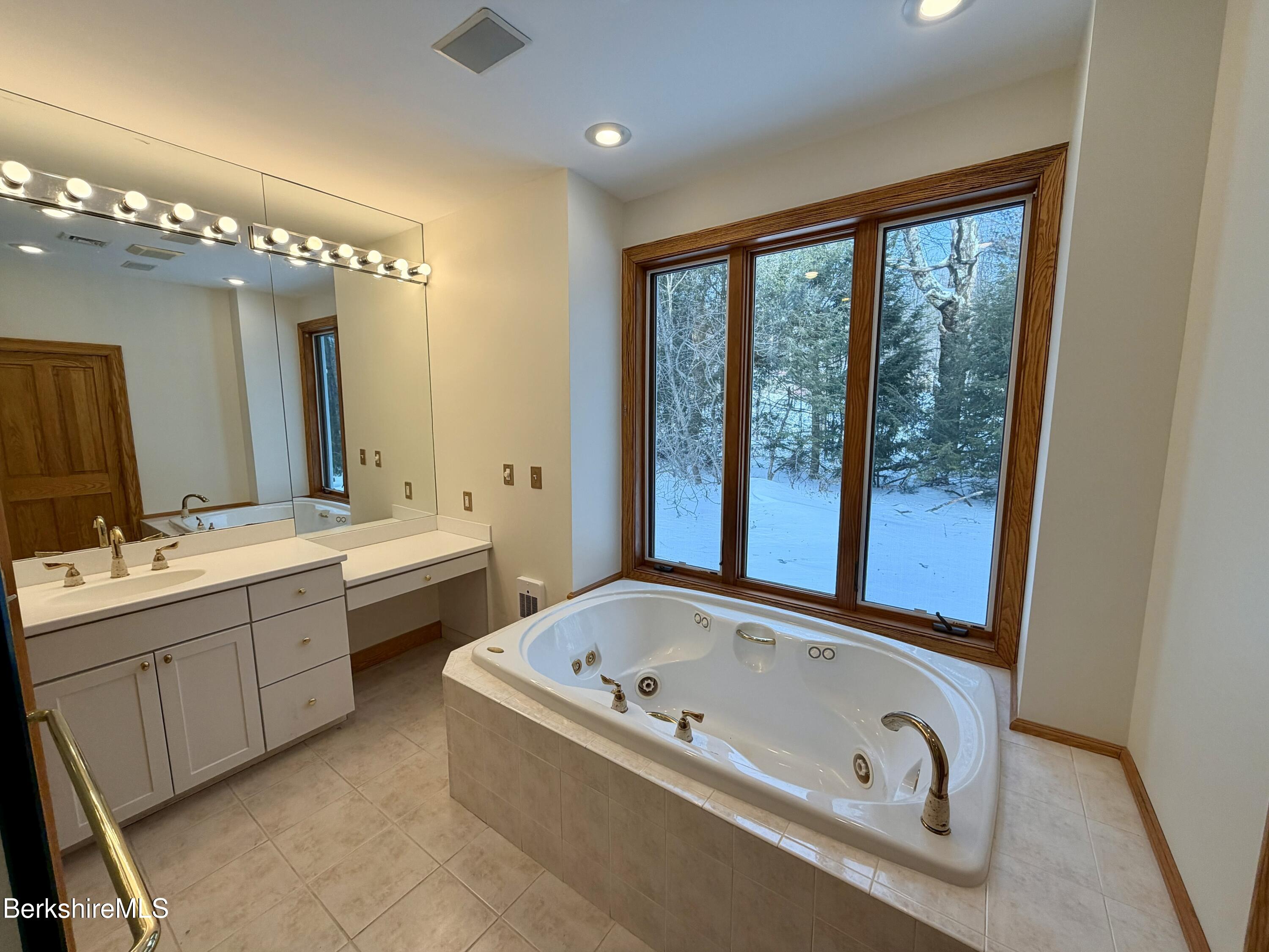 7 Poirot Road Florida, MA 01247 - Photo 39 of 57 a bathroom with a tub sink and mirror