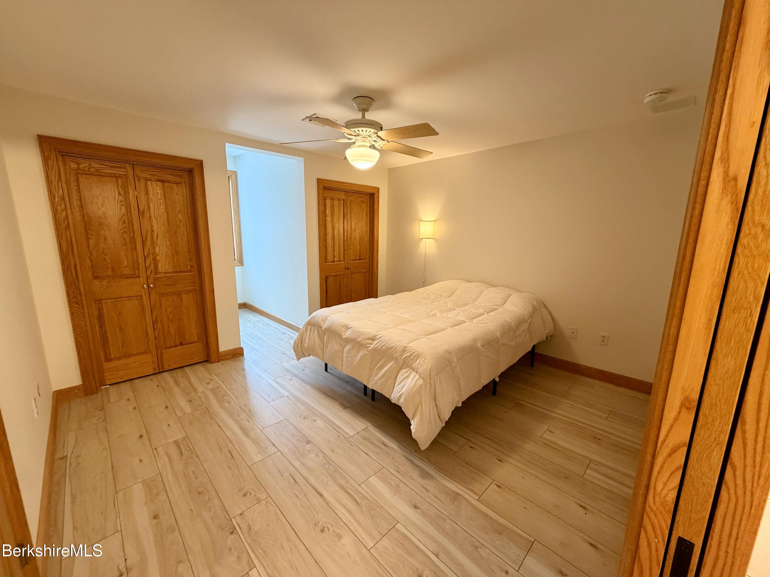 7 Poirot Road Florida, MA 01247 - Photo 43 of 57 a bedroom with a bed and wooden floor