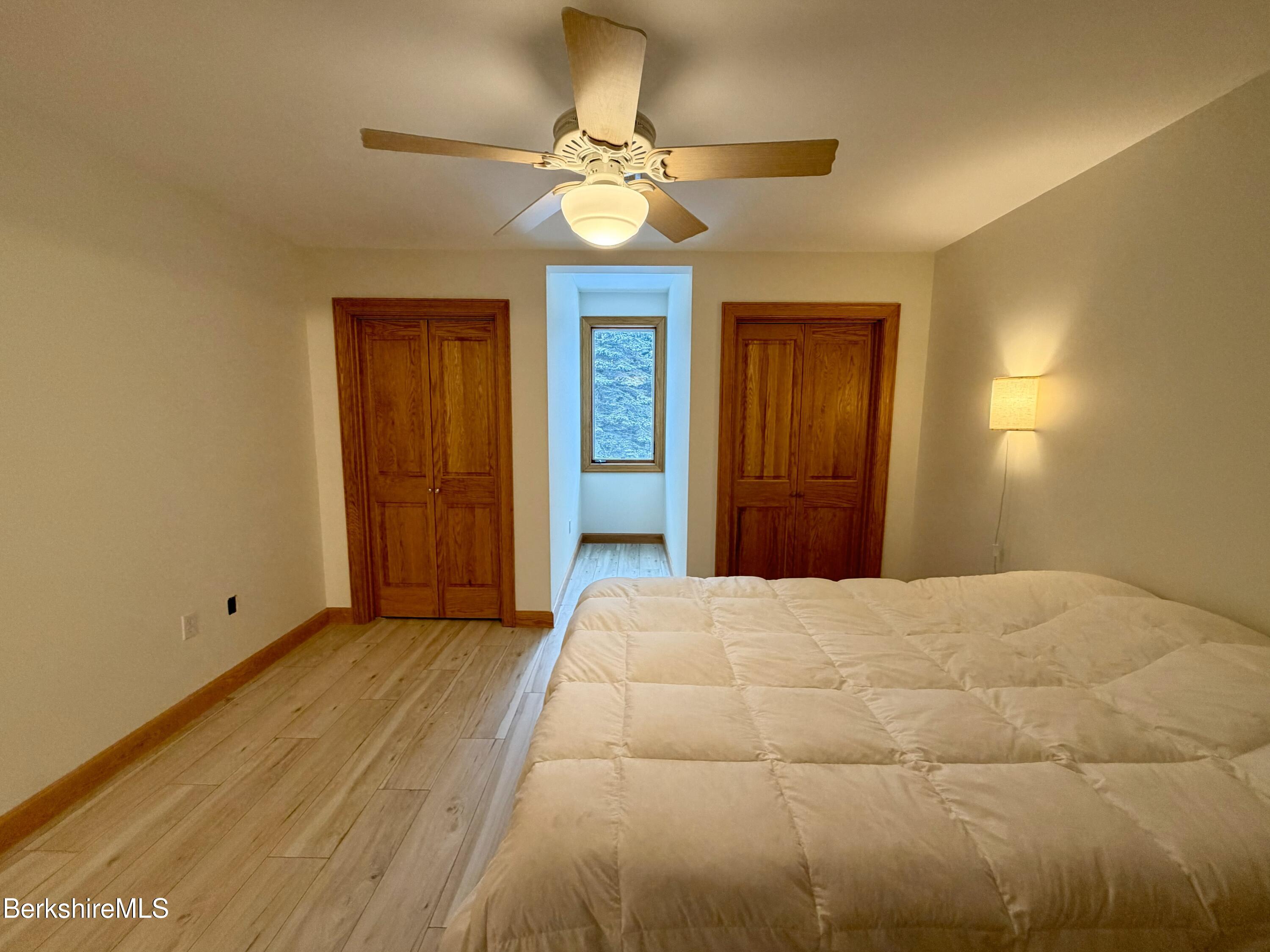 7 Poirot Road Florida, MA 01247 - Photo 44 of 57 a bedroom with a bed and a chandelier