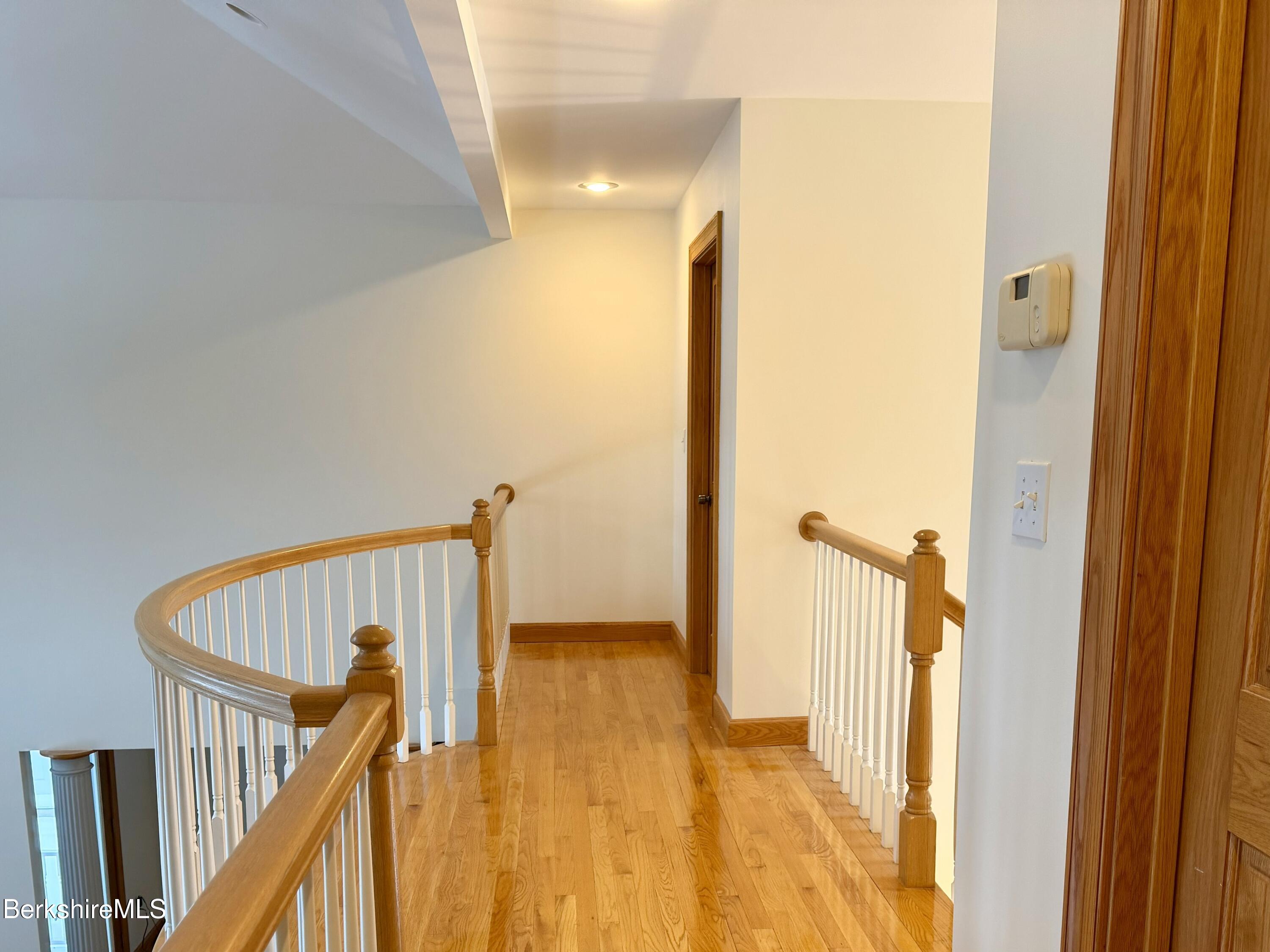 7 Poirot Road Florida, MA 01247 - Photo 45 of 57 a view of a hallway with wooden floor and staircase