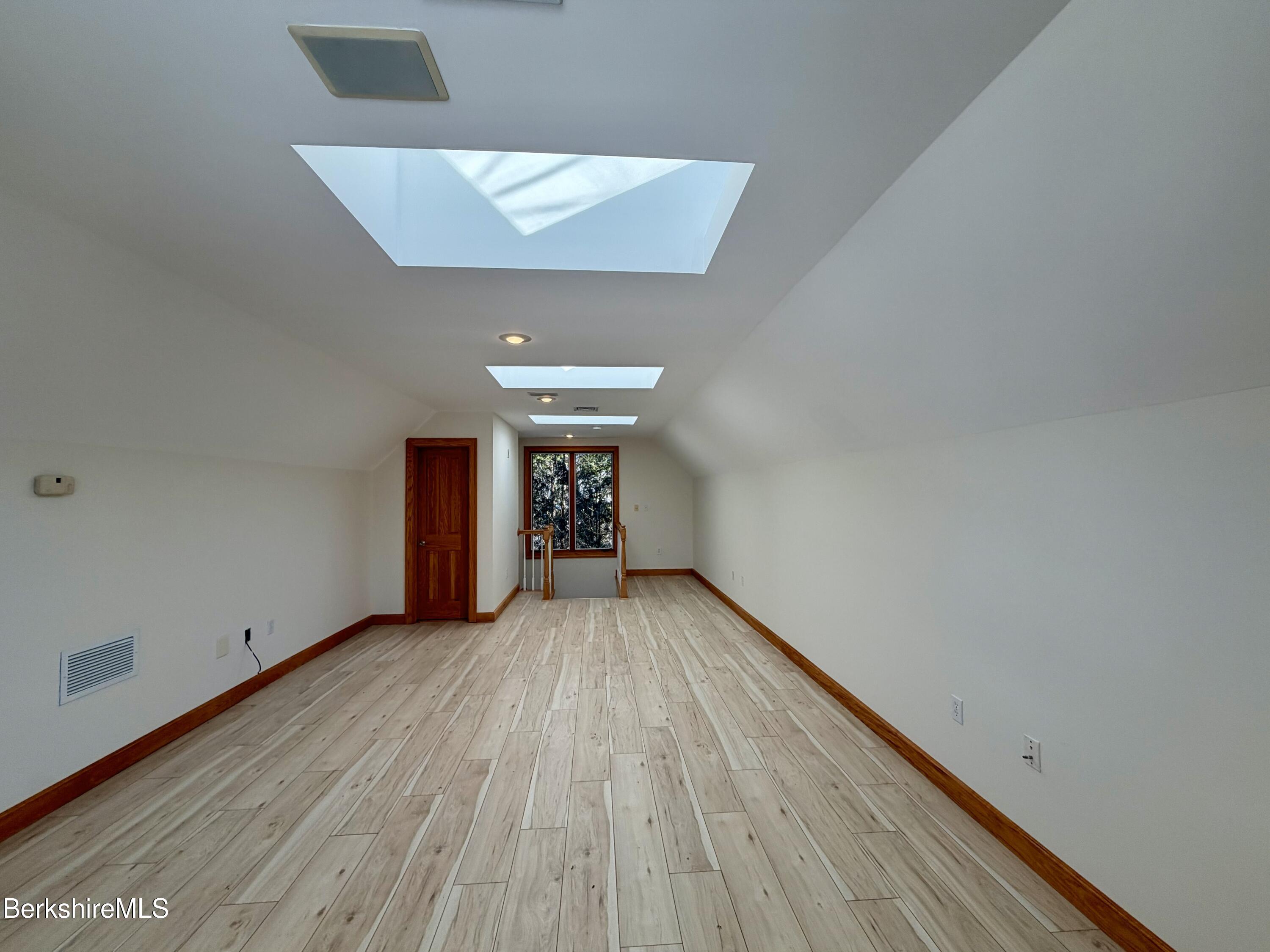 7 Poirot Road Florida, MA 01247 - Photo 50 of 57 a view of an empty room with wooden floor