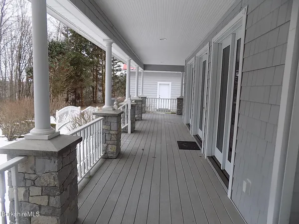 a view of a house with wooden deck