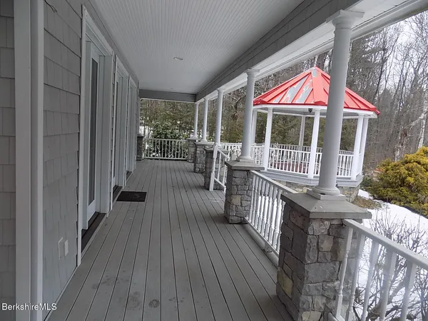 a view of a house with wooden deck and backyard