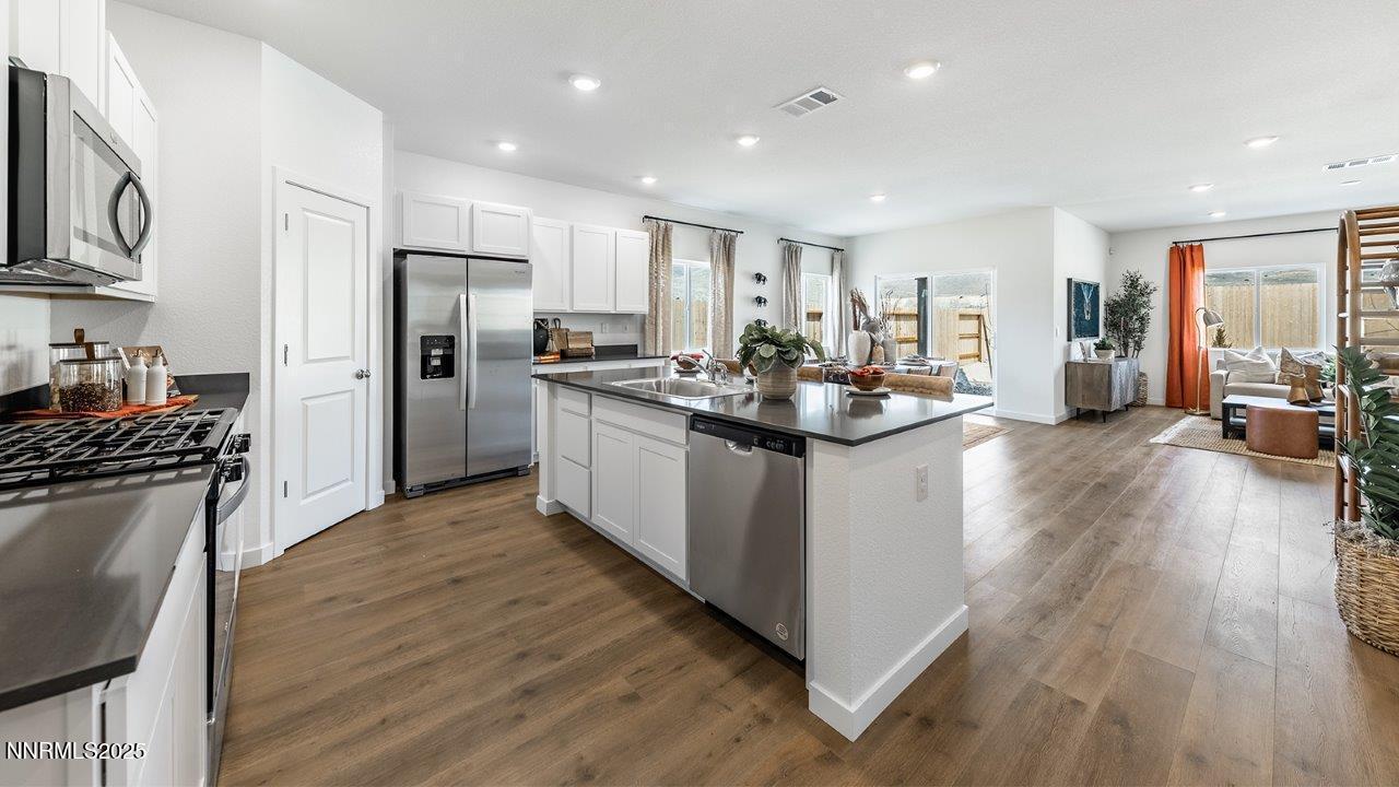 612 Union Road, Unit LOT #64 Dayton, NV 89403 - Photo 5 of 25 a kitchen with refrigerator a sink and wooden floor