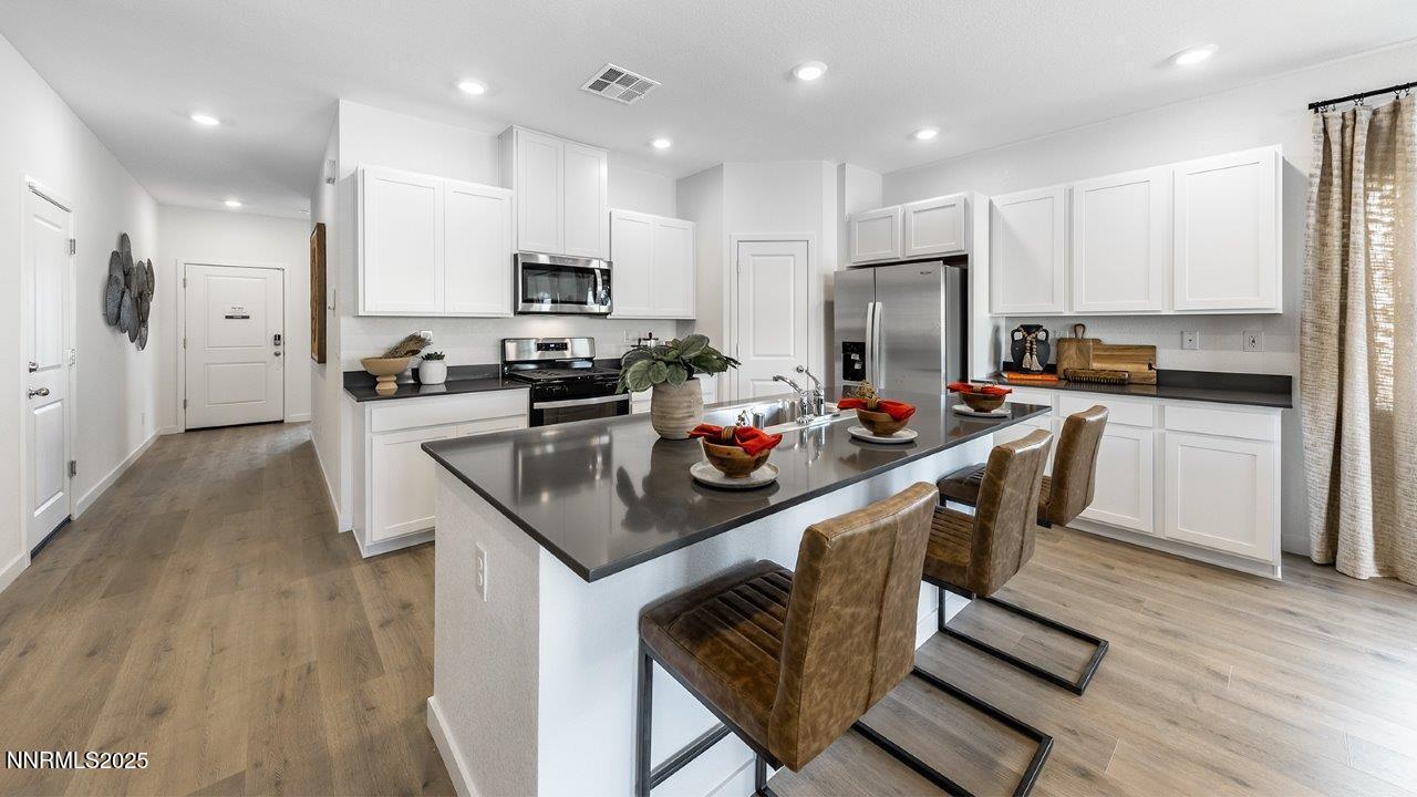 612 Union Road, Unit LOT #64 Dayton, NV 89403 - Photo 6 of 25 a kitchen with kitchen island granite countertop a sink a stove a refrigerator cabinets and a dining table
