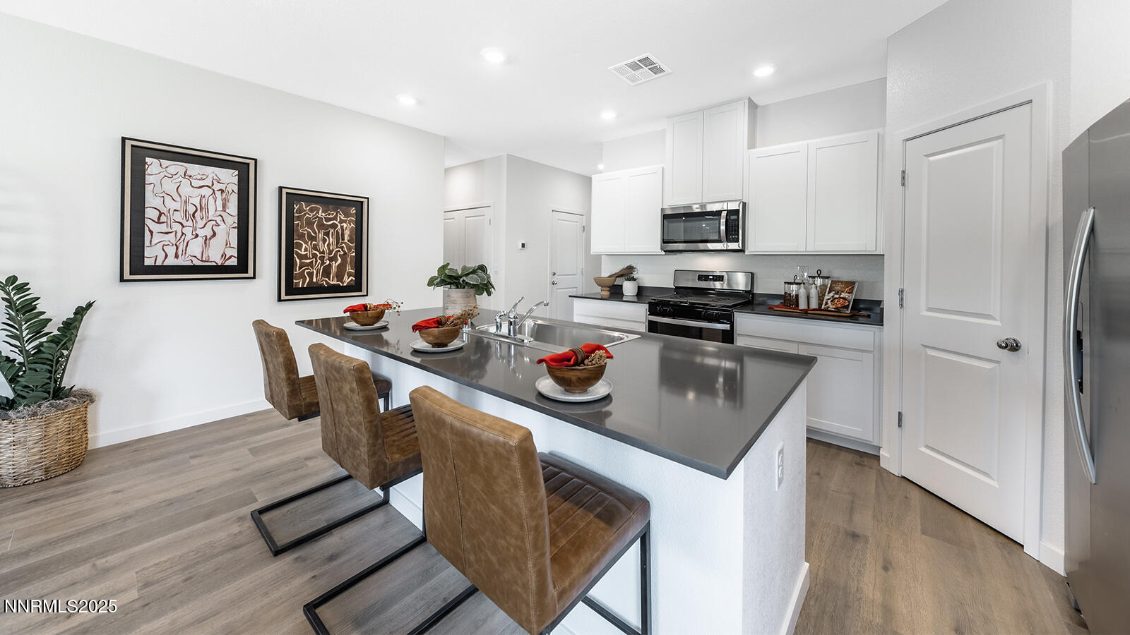 612 Union Road, Unit LOT #64 Dayton, NV 89403 - Photo 8 of 25 a kitchen with stainless steel appliances granite countertop a refrigerator a stove top oven a sink dishwasher and white cabinets with wooden floor