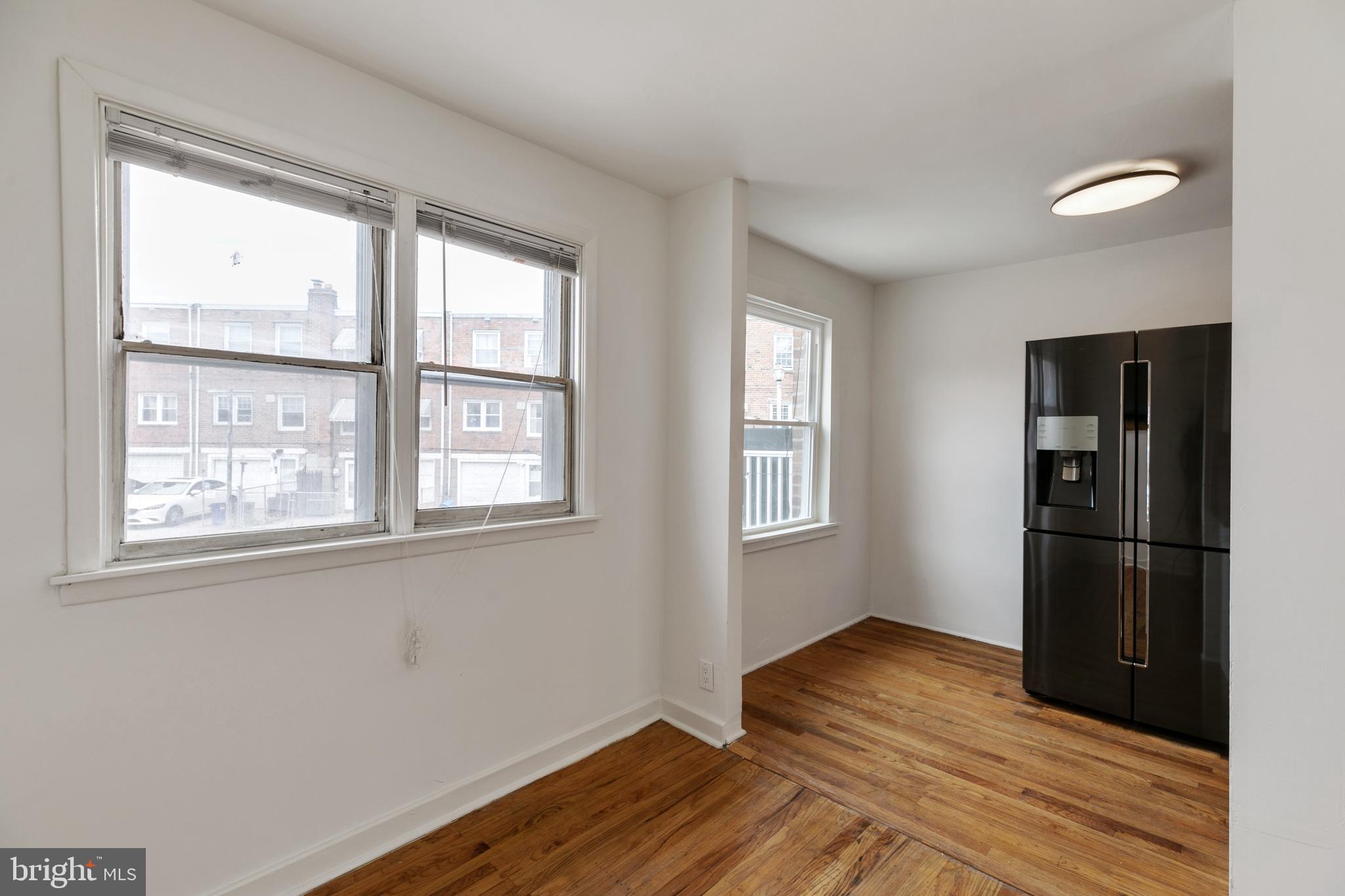 1828 South 29th Street Philadelphia, PA 19145 - Photo 12 of 32 a view of an empty room with wooden floor and a window