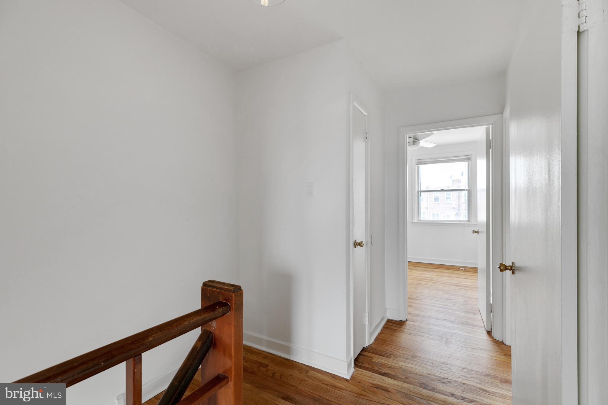 1828 South 29th Street Philadelphia, PA 19145 - Photo 14 of 32 a view of a hallway with wooden floor